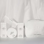 Nurture Pack; Shampoo, Hair Mask, and Conditioner with a Conditioner Distribution Comb Resting On Top, Beside Vegan-Leather Beauty Bag